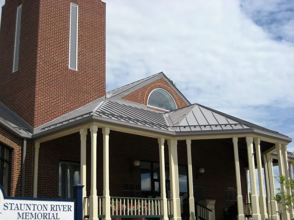 Skilled roofing craftsmen working on a residential roof in Long Branch